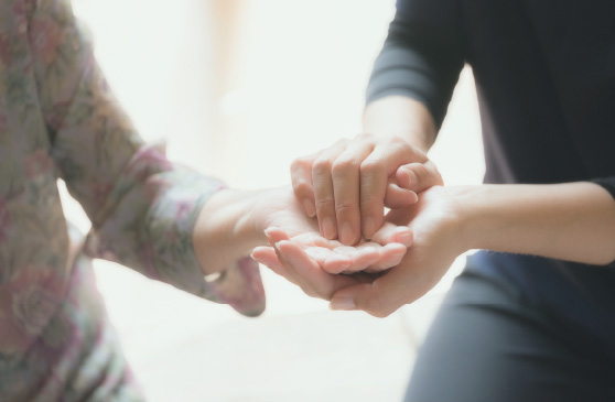 利用者の手をスタッフが握る